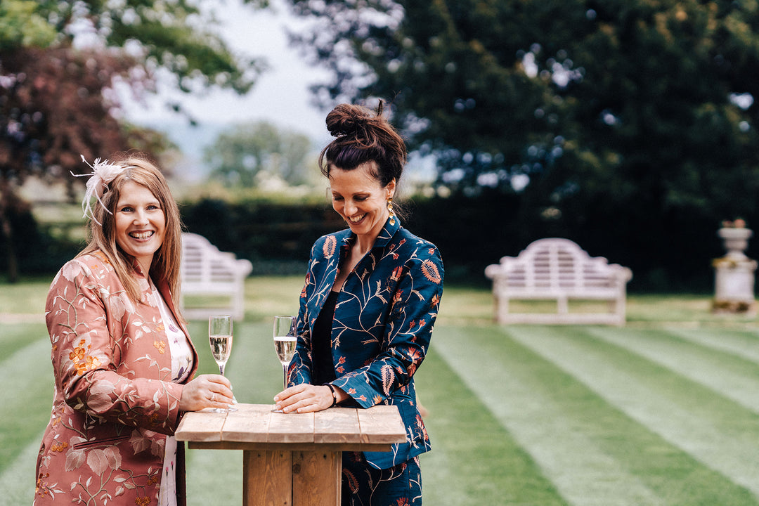 Elegant party outfits. Silk green floral suit and long floral coat in pink