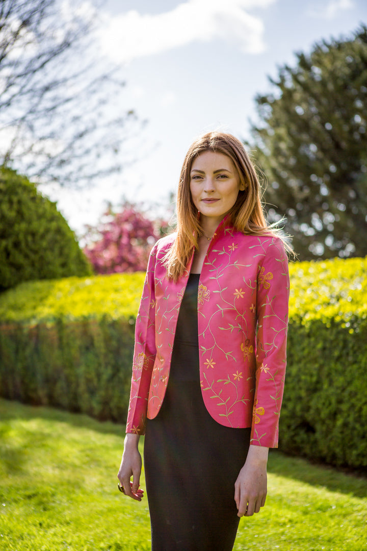 tailored deep pink jacket worn over black dress