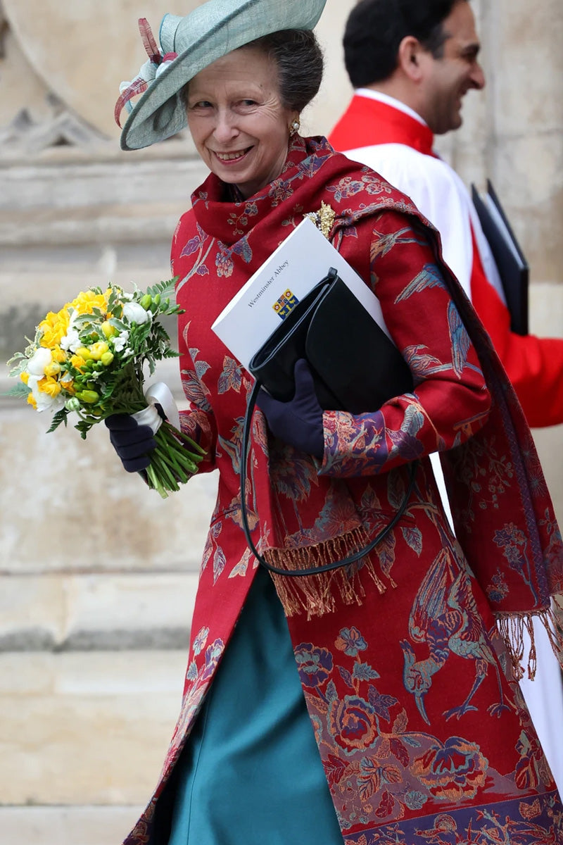 Princess Anne wearing Shibumi shawl. Small fashion brand loved by royals. Floral red shawl with matching coat. 