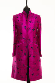 Bright pink coat with blue and black embroidery. 