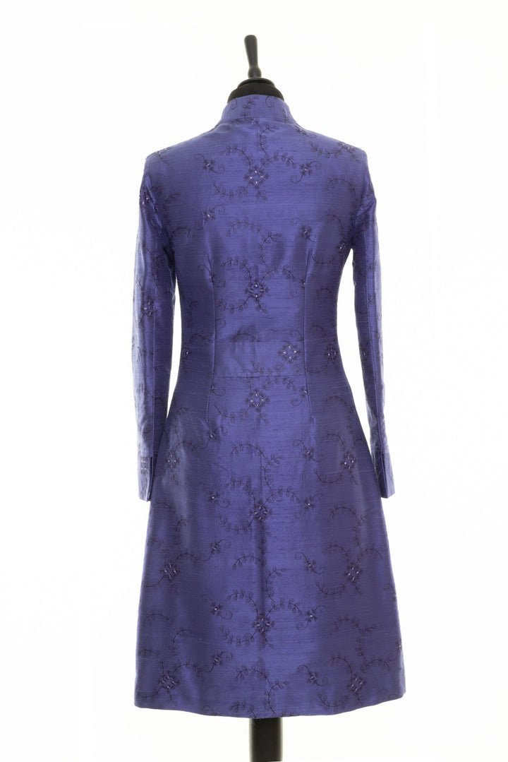 Mid lengths women's coat in periwinkle blue with delicate floral embroidery. 