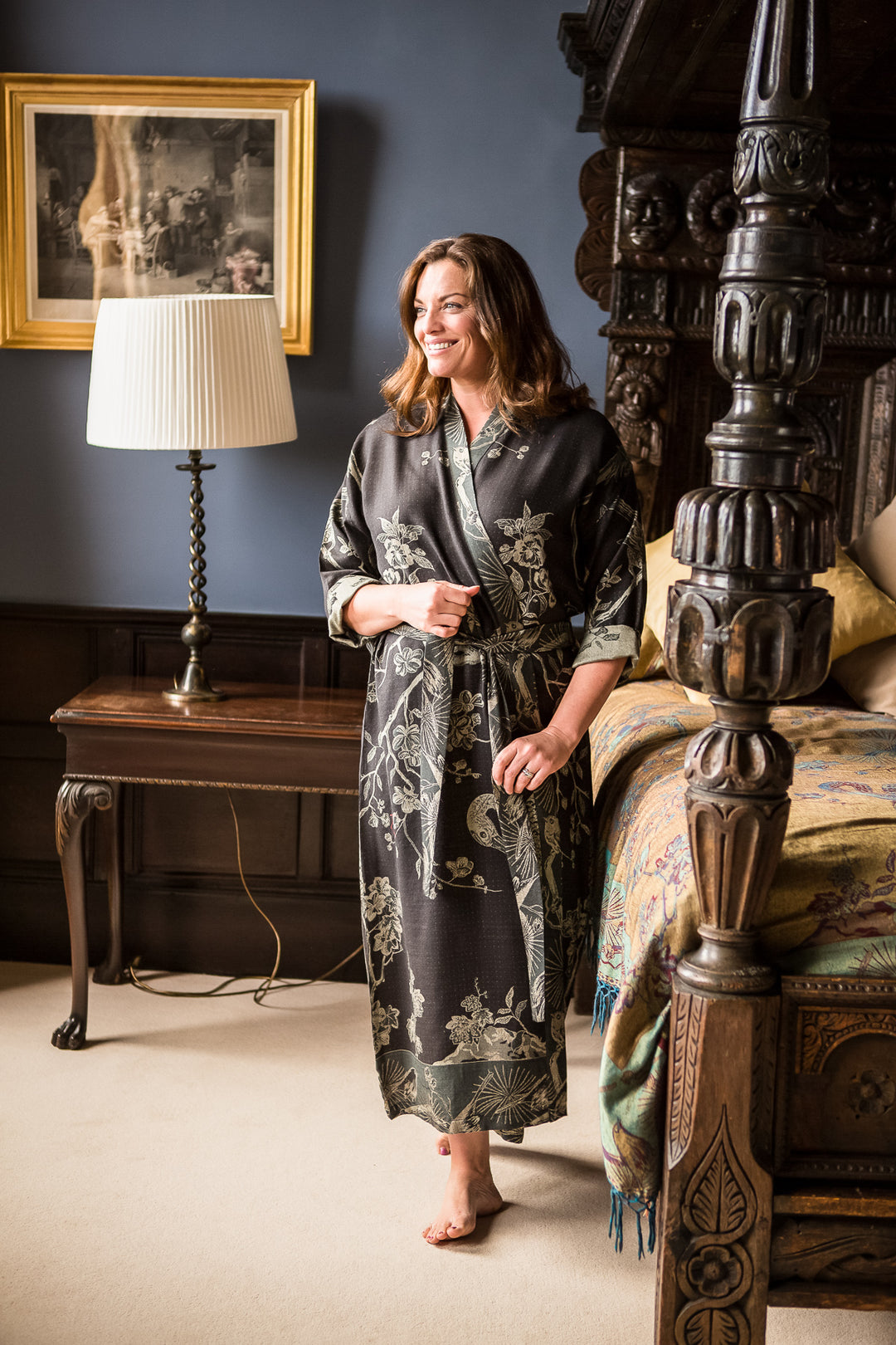 Black long dressing gown with floral pattern. Belted gown for women, made from cashmere. Plus size model wearing black floral dressing gown. 