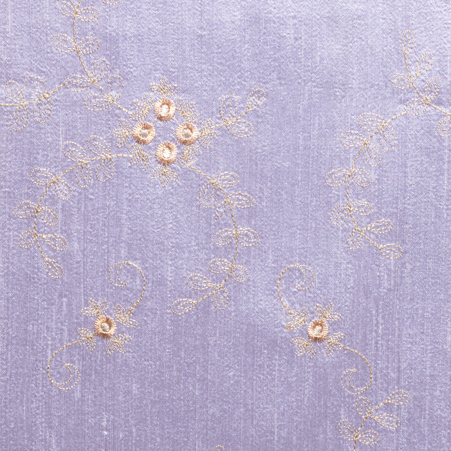 Lilac silk embroidered fabric with ivory flowers. 