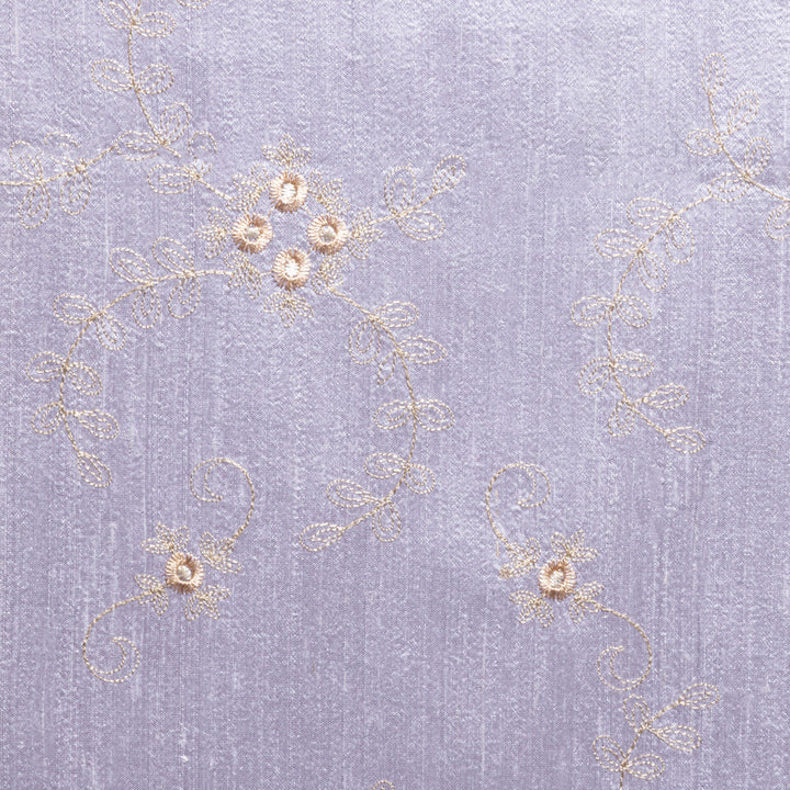 Silk lilac fabric with golden embroidered flowers. 