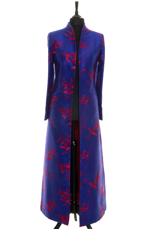 Elegant full lengths coat in blue with red floral pattern. 