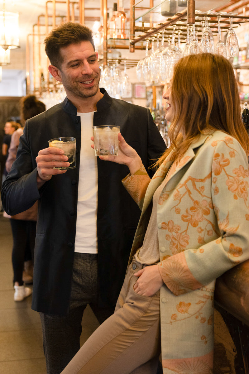 man and women at the bar, he is wearing silk smart jacket with mandarin collar