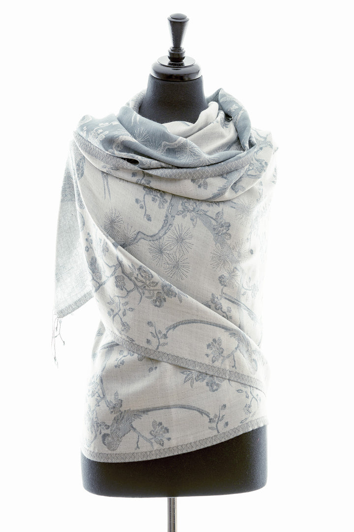 Cashmere silk blend shawl in a pale grey cashmere fabric with a blue undertone, a floral pattern in a darker grey