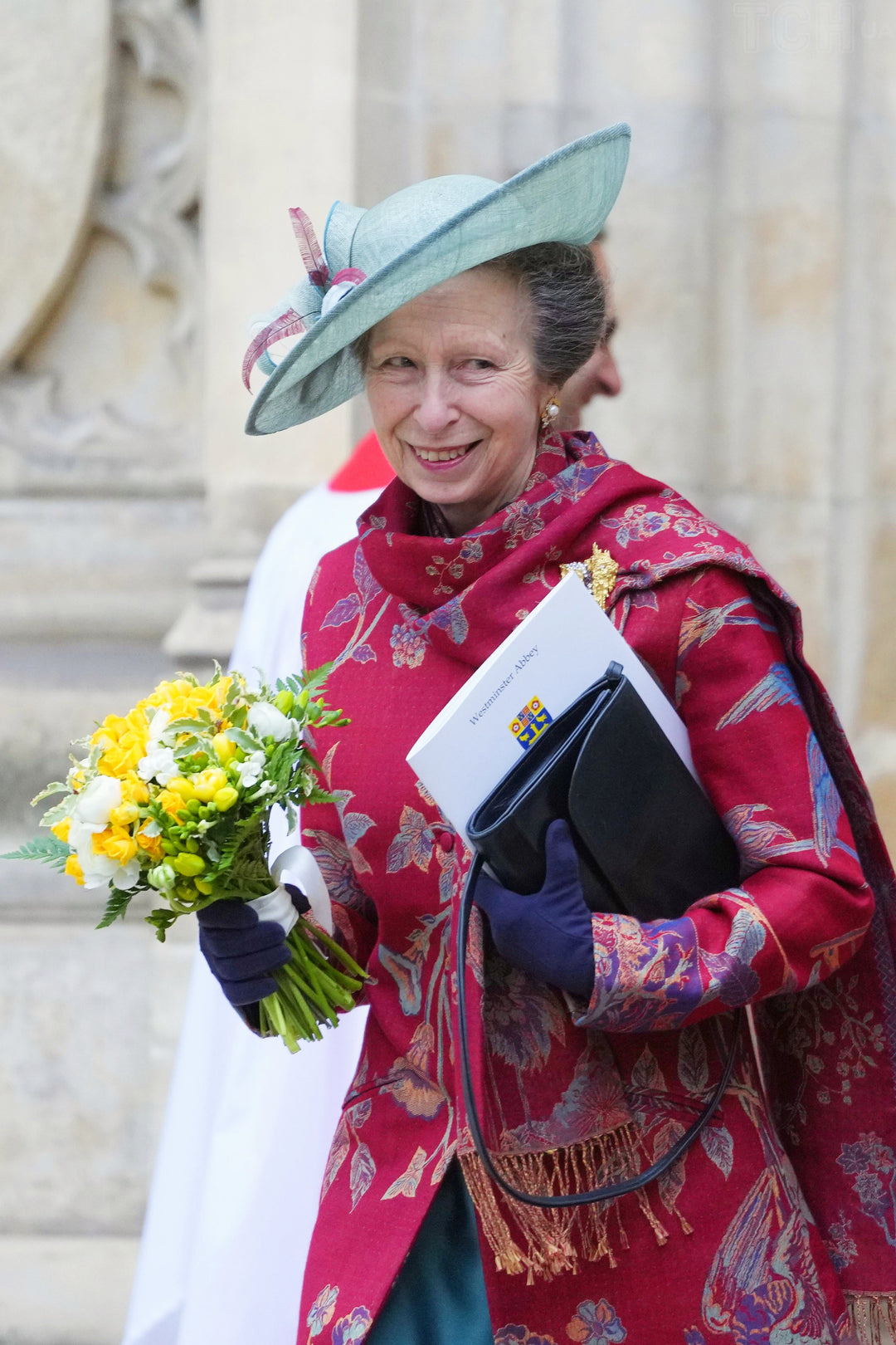 Princess Anne's favourite brand Shibumi. She is wearing a red Shibumi coat with floral pattern and handmade cashmere Shawl. 