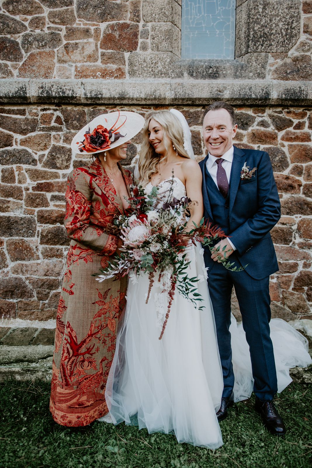 Customers photo of mother and the bride. The mother of the bride is wearing a Shibumi maxi coat handmade from cashmere with floral pattern. 