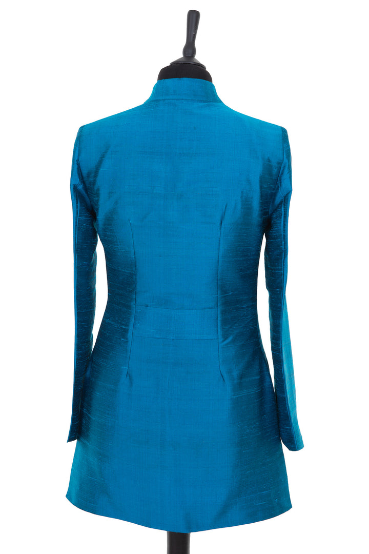 Womens longline jacket with a soft curved collar in a bright kingfisher, teal blue plain raw silk