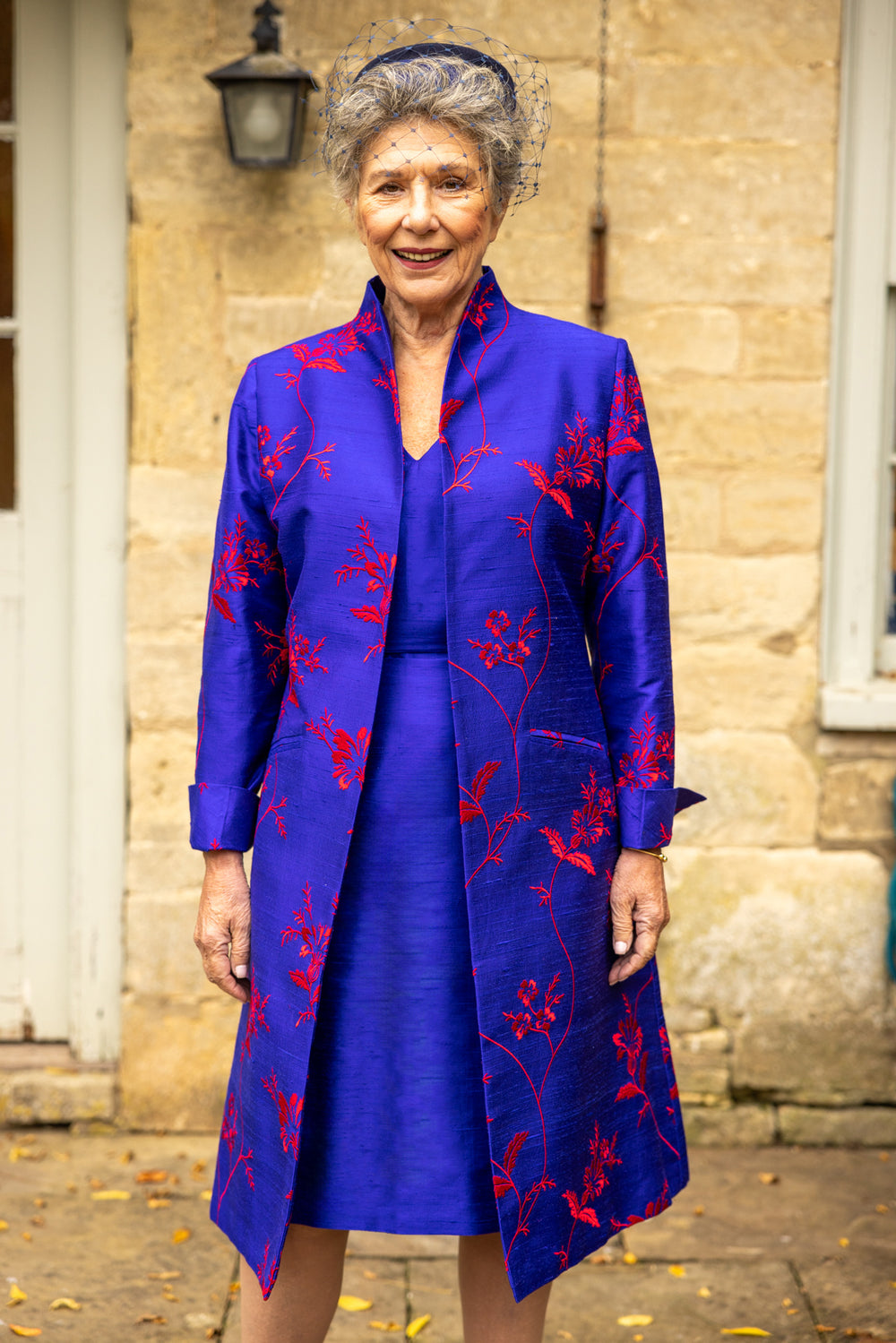 Shibumi French cobalt coat with raw cobalt dress. Mid length women's coat in bright blue with big red floral pattern.  With shift silk dress in blue. 