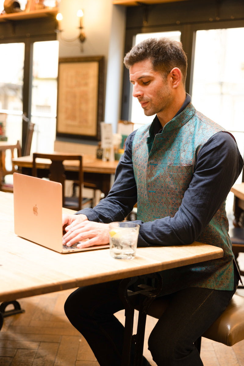 man waring smart looking waistcoat in casual way with jeans 