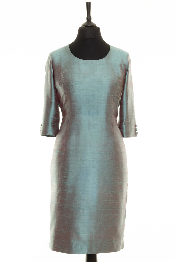 Smokey blue silk dress with round neckline and longer sleeves. This is a raw silk knee length dress. 