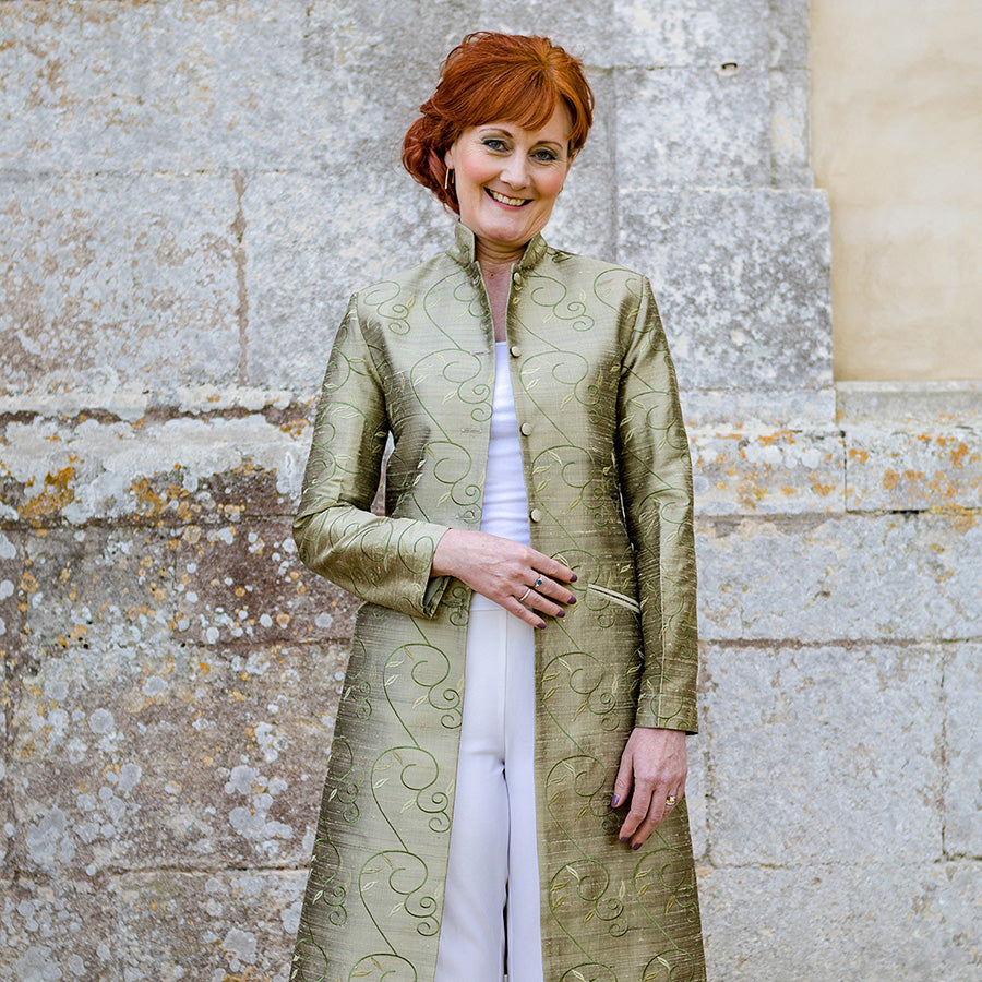 Mother of the bride wearing a green silk jacket. 