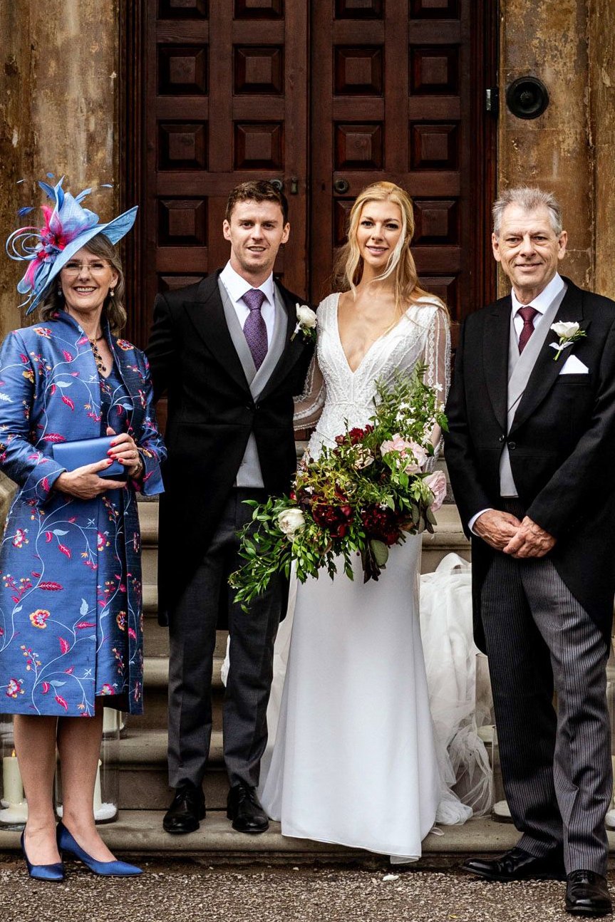 Mother of the bride wearing matching silk coat and dress. Blue elegant floral coat and shift silk blue dress with same floral pattern. 