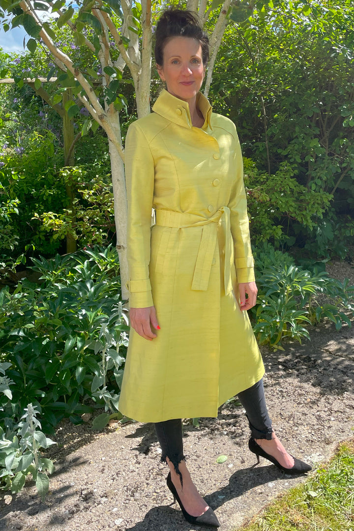 Elegant yellow trench coat. Wedding guest outfit in yellow. 