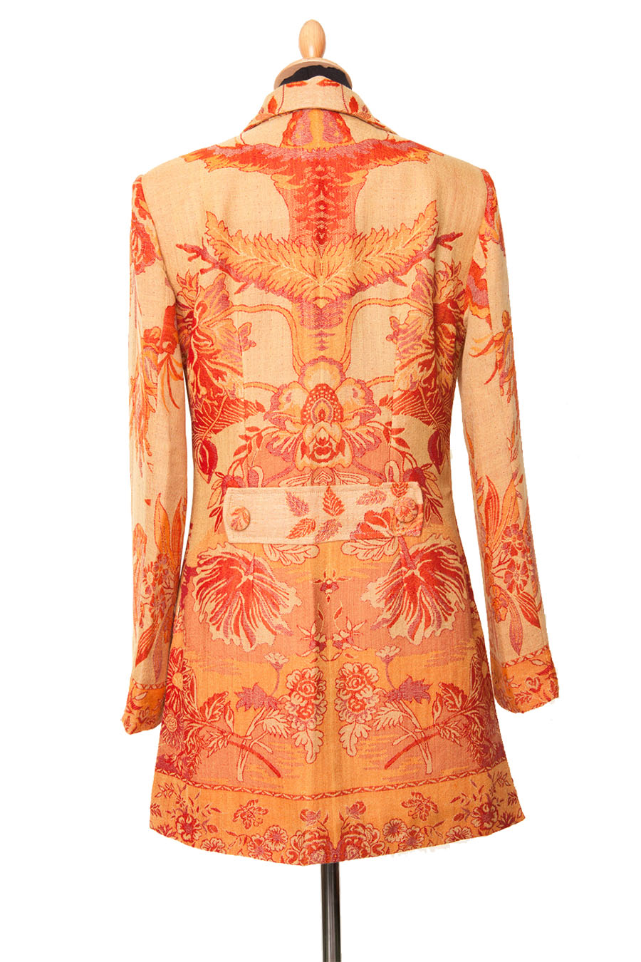 Back of an orange and yellow women's jacket with tree of life pattern. 