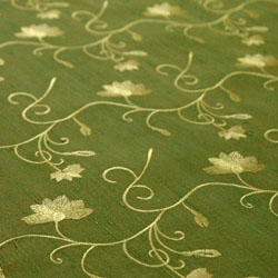 embroidered silk fabric in green and gold. 