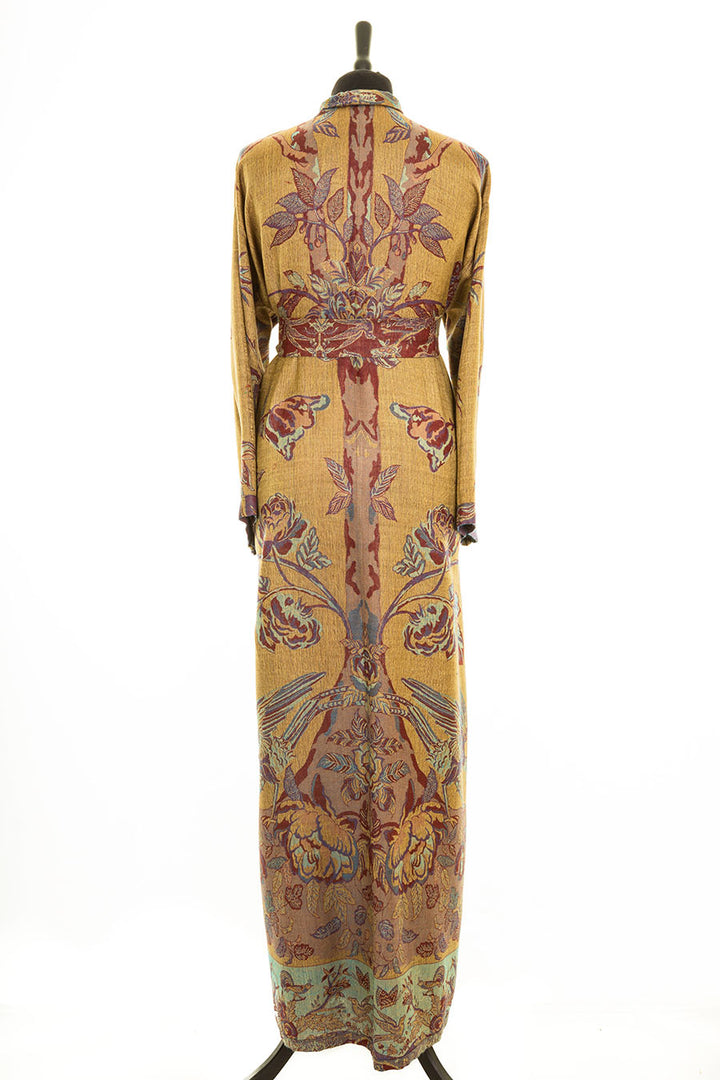 Back of a long cashmere dressing gown with a belt and tree of life pattern. It is handmade in yellow and blue and red. This gown is reversible and the inside is purple with yellow flowers. 