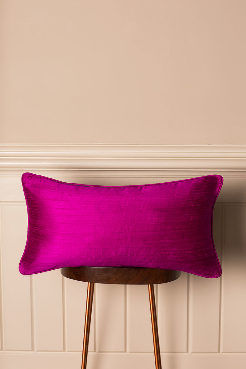 Bolster silk cushion in bright pink.