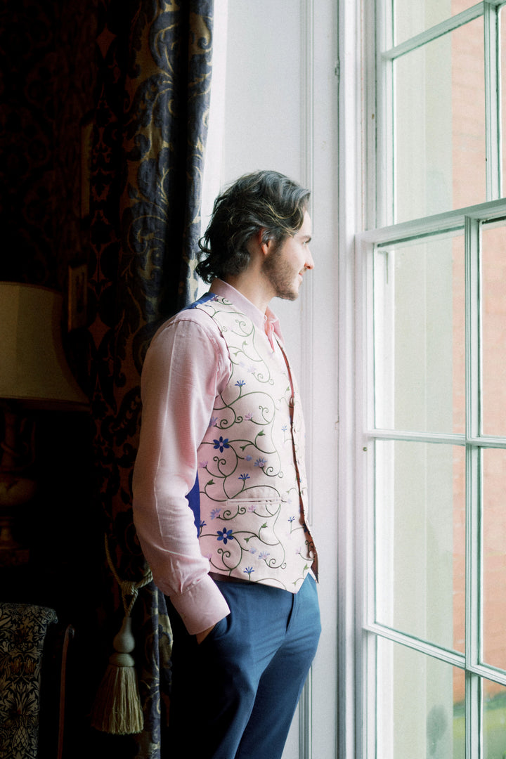 Groom wearing shibumi silk embroidered waistcoat that has floral pattern. 