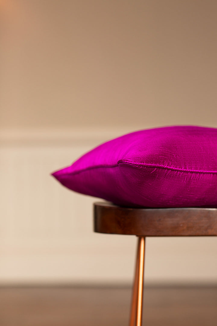 Dark pink sofa cushion made from raw silk. 