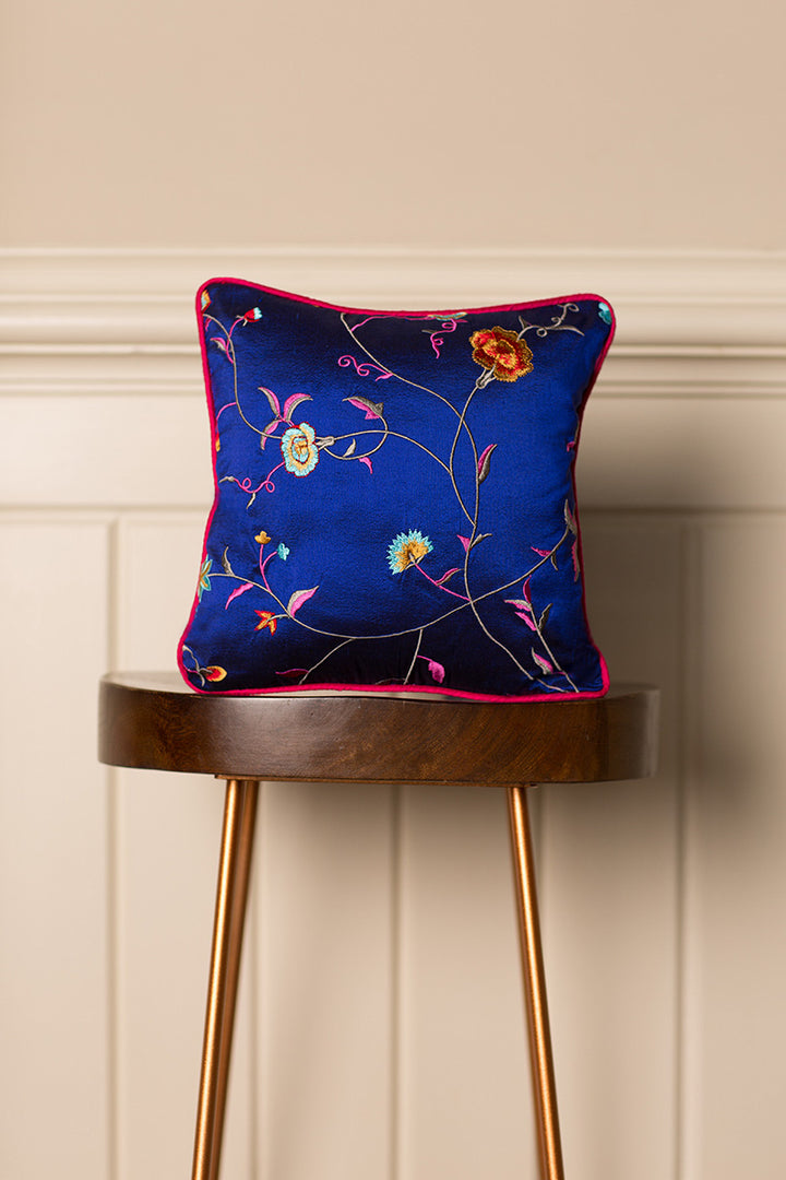 Small embroidered silk cushion with floral pattern. 