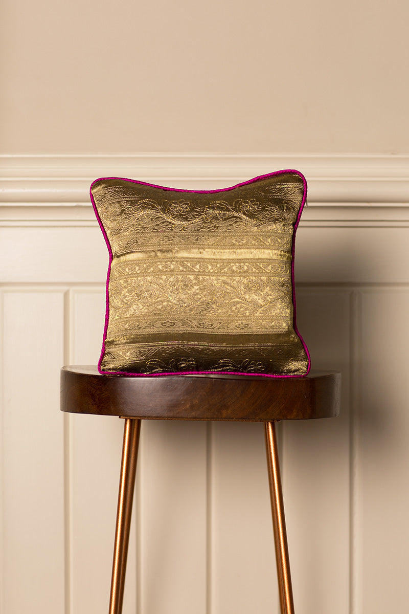 Small gold cushions with pink pipping. 