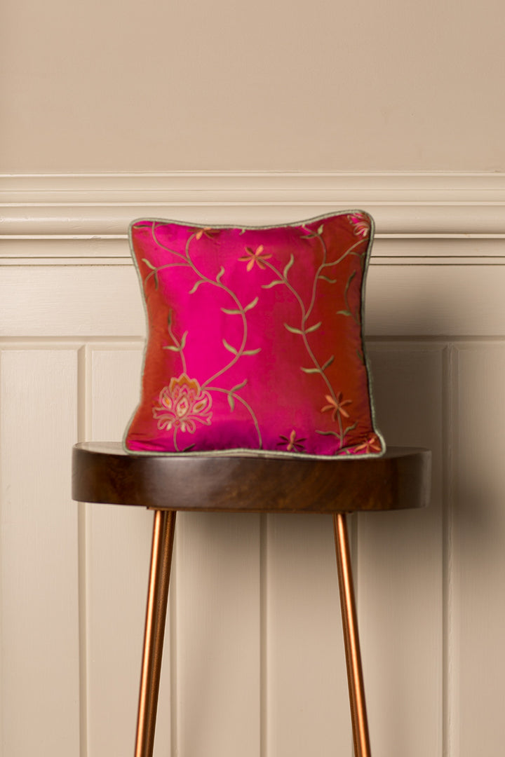 Bright red silk cushion with golden floral pattern 