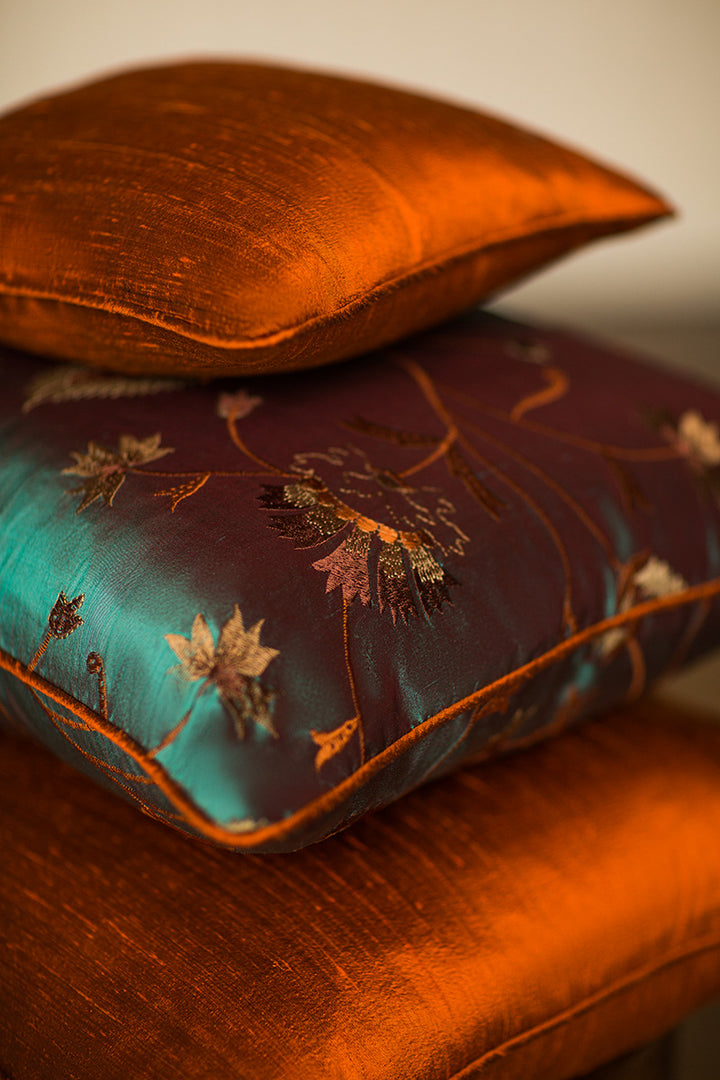 Orange cushions and silk embroidered cushions. 