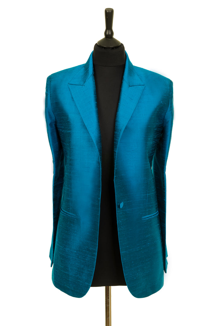 Raw silk blazer in blue with one button and two pockets. 