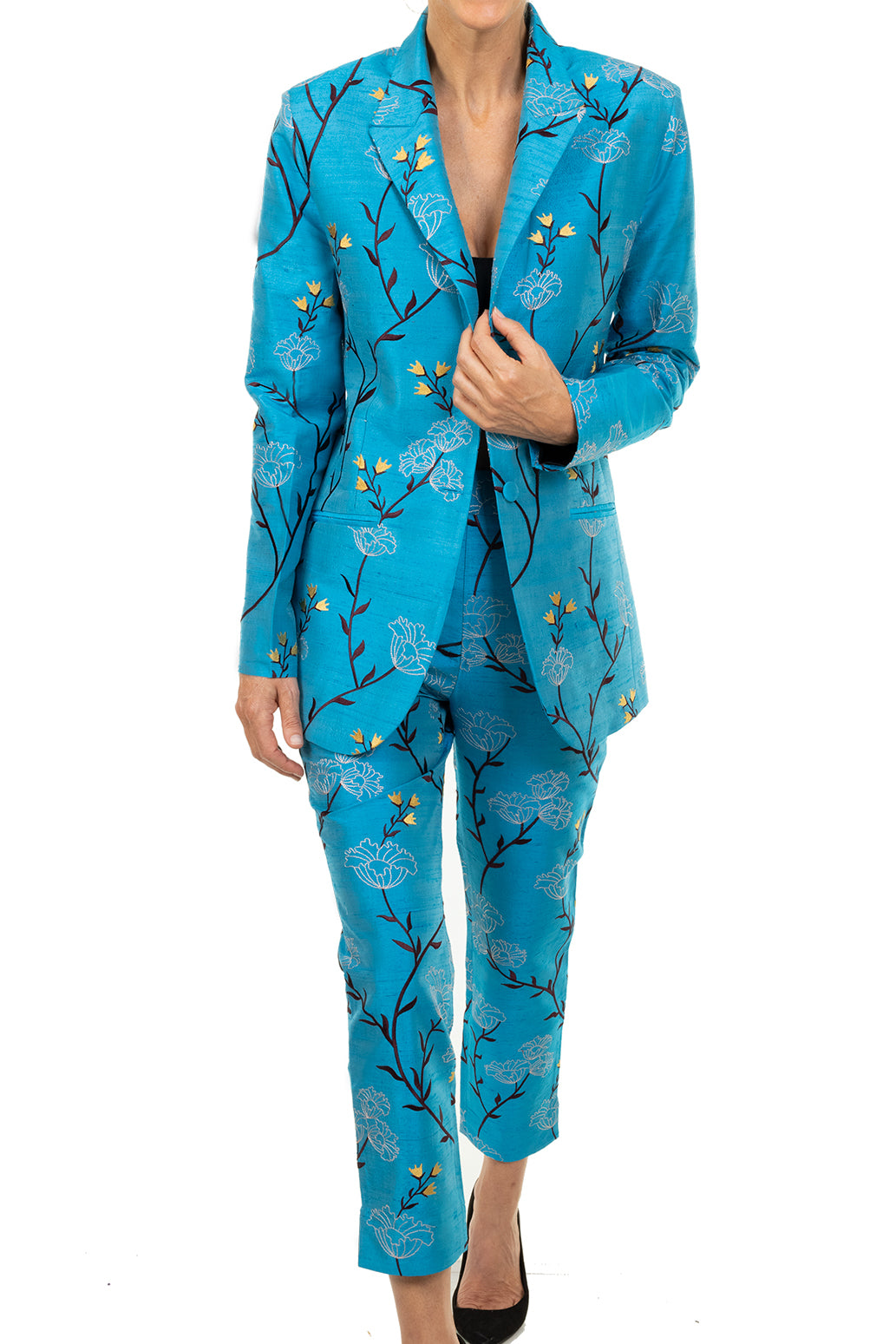 Women's blazer in turquoise. Worn with matching trousers. Both have soft embroidery - black and yellow flowers. Wedding suit for women.