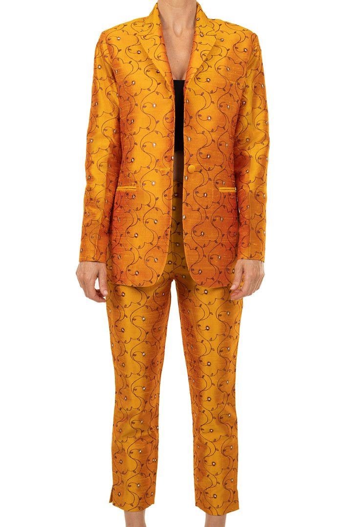 Yellow suit for women. Straight trousers with flower pattern and matching jacket that is a classic cut. 