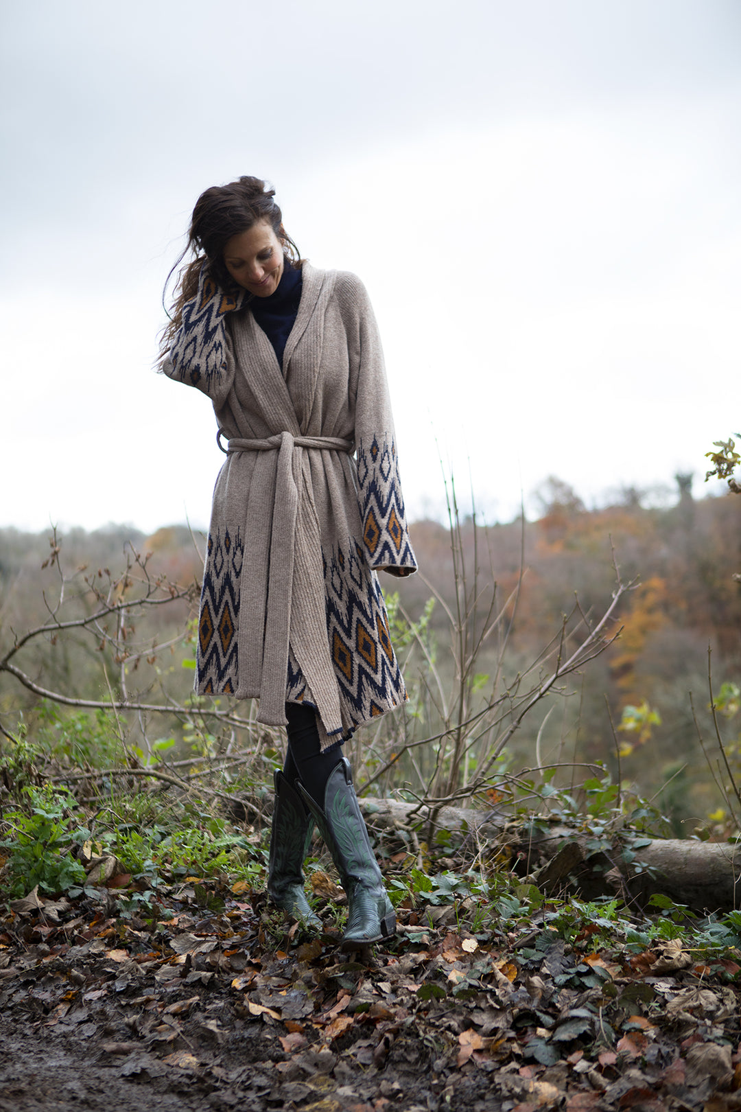 Lady on a walk in the forest, wearing long cardigan. 